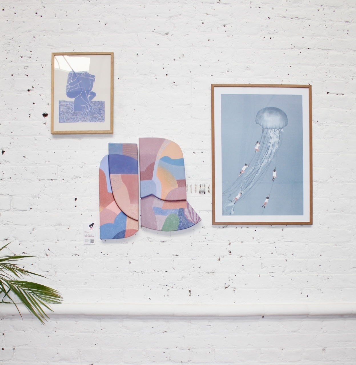 Art displayed on a white wall in a living space